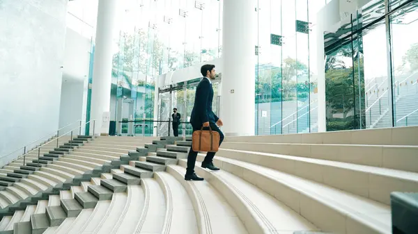 Professional business man going up the stairs. Successful man going up the stairs while explore a new thing. Represented traveling, getting a promotion, finding a new job, increasing skill. Exultant.