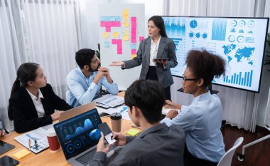 Genç Asyalı iş kadını modern toplantıda TV ekranında veri analizi paneli sunuyor. Bir grup iş adamıyla konferans odasında iş sunumu. Uyum