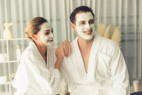 在度假期间 身穿浴衣 戴着面霜面罩的一对幸福的夫妇在温泉度假胜地或宾馆里享受着宁静的氛围 抚慰面部水疗及护肤治疗 精益舒缓 — 图库照片