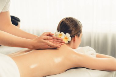 Kafkas çift müşterisi stres önleyici spa masajının keyfini çıkarıyor ve lüks otel veya oteldeki gündüz açık hava ortamında güzellik teniyle eğleniyor. Sessiz.