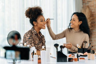 Kadın nüfuzlu kişi canlı yayında video görüntülerini çekiyor. Makyaj çok önemli sosyal medya ya da blog. Kozmetik stüdyosu ışıklandırmalı mutlu genç kız çevrimiçi pazarlama oturumu yayını için..