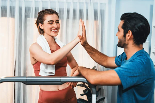 Athletic body and sporty young couple or workout buddy in sportswear high five after successful in home workout exercise at gaiety home exercise and healthy lifestyle concept.
