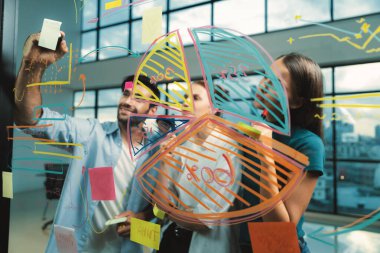 İş arkadaşı plan yaparken cam duvarı işaret eden yetenekli bir proje yöneticisi. Çeşitli iş adamları birlikte çalışıyor, pazarlama fikri ya da iş planı üzerinde kafa yoruyorlar. Yaratıcı bir başlangıç. İzleme.