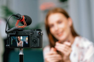 Kadın Etkilenen Vlog video görüntülerini sosyal medya ya da blog 'da en üst düzeyde yayınlıyor. Kozmetik stüdyosu ışıklandırmalı mutlu genç kız çevrimiçi pazarlama oturumu yayını için..