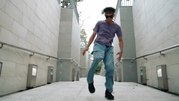 专业的霹雳舞蹈演员在狭窄的走廊表演街头舞蹈 熟练的快乐的亚洲嬉皮士走向音乐 同时在狭窄的墙壁上展示B Boy步法 现代生活方式 2024年户外运动 神气活现 — 图库视频影像