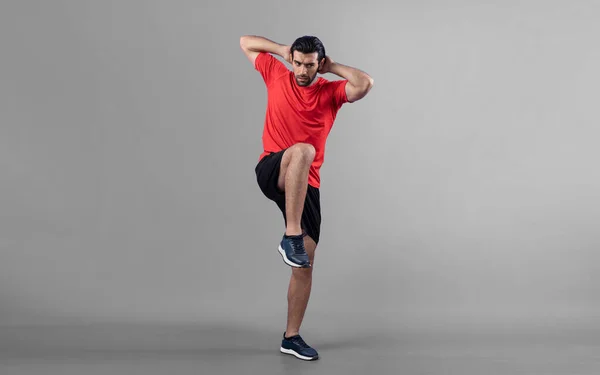 Full body length gaiety shot athletic and sporty young man with fitness warmup and stretching body for pre exercise posture on isolated background. Healthy active and body care lifestyle.