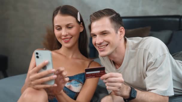 커플은 카드로 지불하기 스마트 온라인 디지털 지갑을 사용하여 침실에 모바일 — 비디오