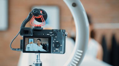 Arka görünüm, kamera ekranında kadın nüfuzunu gizler. Video görüntüleme, video görüntüleme, giysi, sosyal medya ya da blog. Canlı yayın için canlı stüdyo ışıklandırması olan kız canlı yayın pazarlama kaydı