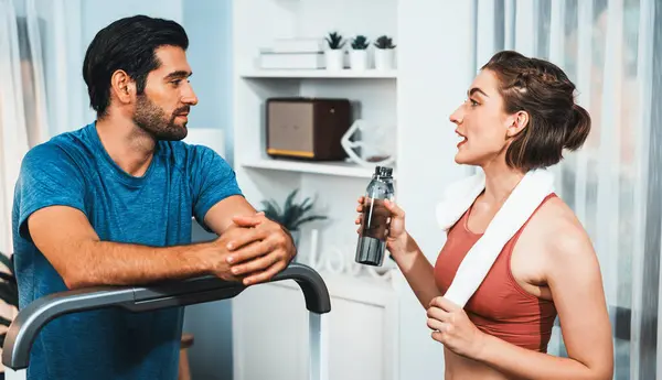 Athletic body and sporty young couple or workout buddy in sportswear warmup or resting after finishing in home workout exercise at gaiety home exercise and healthy lifestyle concept.