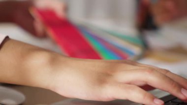 Grafik tasarımı için renk seçimi yapan ve beyin fırtınası yapan iki tasarımcının yavaş çekim çekimi ya da tasarım bürosunda kromatik danışmanlık hizmeti isteyen bir müşteri. Değiştirilmiş