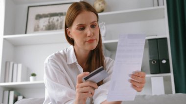 Stresli genç bayanın kredi kartı borçlarıyla ilgili mali sorunları var. Kötü kişisel para ve mortgage ödeme yönetimi krizinden korunmak için. Kadınlar aşırı harcama yüzünden finansal iflastan endişe ediyorlar.