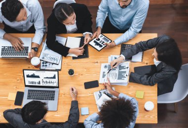 Üst düzey çok ırklı analiz ekibi, stratejik karar için finansal verileri analiz etmek amacıyla dizüstü bilgisayarda BI gösterge ekranını kullanıyor. Fintech pazarlama göstergelerini analiz ediyor. Uyum