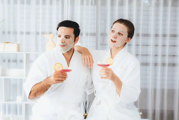 stock image Serene modern daylight ambiance of spa salon, couple customer indulges in rejuvenating with facial skincare mask. Facial skin treatment and beauty cosmetology procedure for face. Quiescent