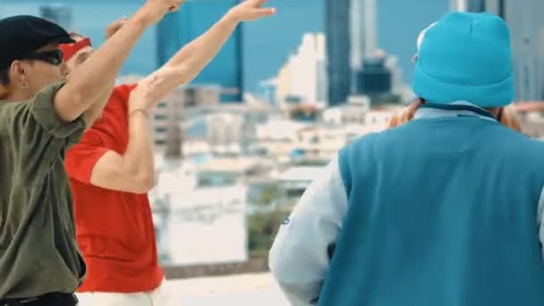 不同的嬉皮士穿着时尚的五颜六色的衣服 在屋顶上与城市的风景共舞 霹雳舞蹈团跳跃 然后在派对上跳音乐 户外运动2024 — 图库视频影像
