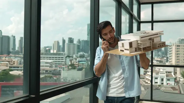Smart Caucasian Engineer Standing Holding House Model While Phone Calling — Stock Photo, Image