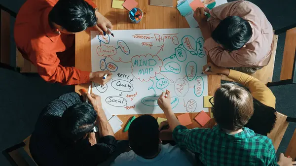 Top down view of business team working together by using mind map brainstorming idea and sharing marketing strategy..Business people wearing casual cloth while planning start up project. Convocation.
