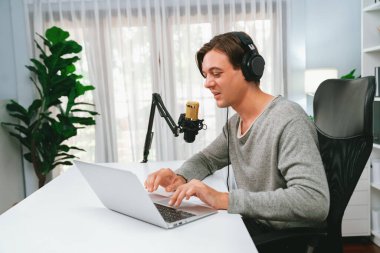 Sunucu kanalı, gülümseyen akıllı yayıncı kaydı, senaryosu ve akıllı telefonuyla sosyal medyada sohbet programı, kulaklık takarak modern ev stüdyosundaki video flamalarını kaydediyor. Bireysel.