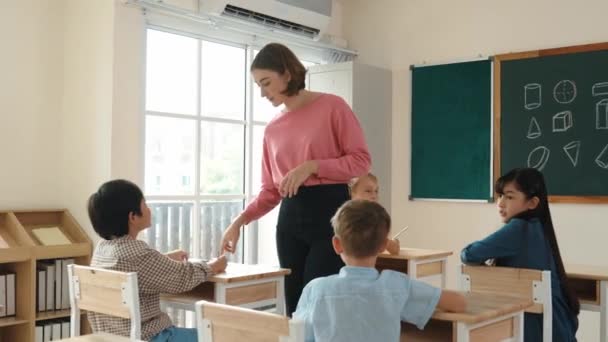 Caucasian Teacher Walking Check Student Homework Classroom While Diverse Children — Stock Video