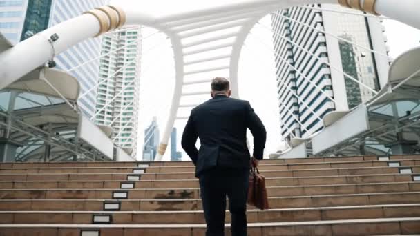 Smart Caucasian Businessman Walking Stairs Surrounded Urban View Back View — Stock Video