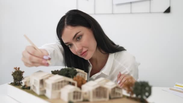 Closeup Young Beautiful Architect Measure Architectural Model While Compare Blueprint — Stock Video