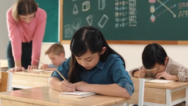 Asian Girl Writing Test Classwork While Looking Camera Classroom Diverse — Stock Video