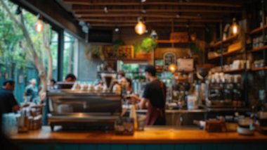 Kalabalık bir kahvehanenin arka planında bulanıklık vardı. Müşteriler içkilerini yudumluyor, baristalar kahve yapıyor, hareketli bir mekan yaratıyorlardı. Saygıdeğer.