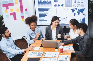 Çok ırklı analist ekibi toplantı masasındaki mali raporu analiz etmek için BI gösterge tablosunu kullanıyor. Çeşitli iş adamlarından oluşan bir grup, FIntech 'in veri analizini başarılı iş pazarlaması için kullanır. Uyum