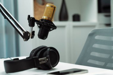 Modern ofis ekipmanları mikrofon ayarları, dizüstü bilgisayar, tablet ve kulaklık boş sunucu kanalı buhar podcast sosyal medya konseptiyle canlı yayında kahveyle hazırlandı. Varsayım.