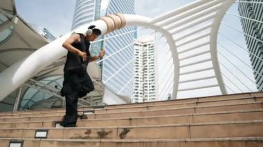 Asyalı hippi kulaklık takar hip hop dinler ve müziğe yönelirdi. Profesyonel break dansçı ya da alçak açılı kamerayla dans ederken merdivenlerden yukarı çık. Açık hava sporu 2024. Yumuşak bir şekilde..