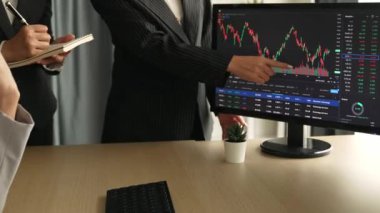 Hisse senedi borsası pazarlamasını analiz eden yavaş çekim şirketindeki yatırımcılar, kayıp için mum bar fiyatını analiz eden monitörlere bakıyor ve kazanç ve kâr elde ediyor. Filizlenen