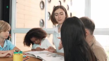 Masada masal kitabı ve renkli kitapla otururken çeşitli öğrencilere hikaye anlatan profesyonel beyaz bir öğretmen. Eğitmenden renkli resim alırken akıllı öğrenci dinlemeyi öğrenir. Etkinlik.