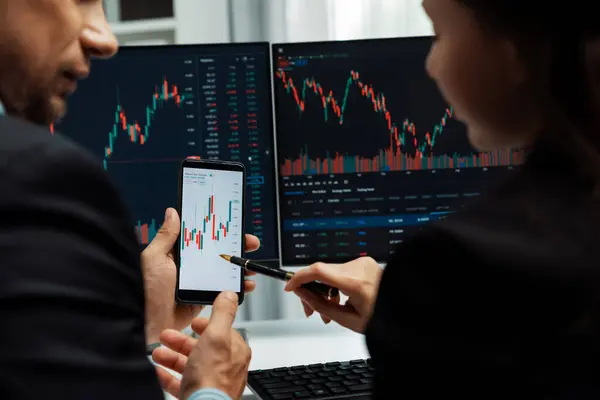 Focusing Phone Discussing Dynamic Stock Market Two Business Traders Online — Stock Photo, Image