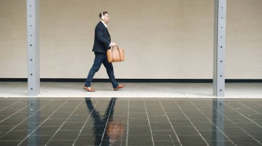 İş adamları onun kulaklığını takıyor ve şehir merkezindeki cadde boyunca işyerine yürüyor. Profesyonel proje yöneticisi toplantıya giderken kulaklıktan rahatlatıcı müzik dinliyor. Urbane.