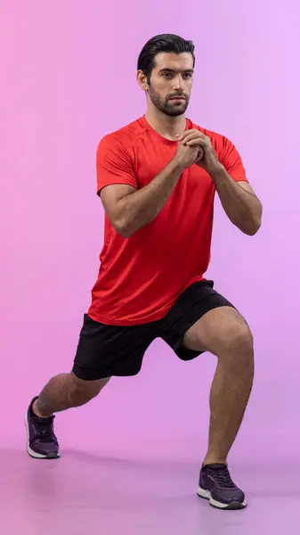 Full body length gaiety shot athletic and sporty young man with fitness in squat exercise posture on isolated background. Healthy active and body care lifestyle.