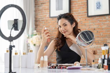 Asyalı Kadın Etkilenen Vlog 'ta canlı yayın yapan videolar sosyal medya ya da blog' un çoğunu oluşturuyor. Kozmetik stüdyosu ışıklandırmalı mutlu genç kız çevrimiçi pazarlama oturumu yayını için.