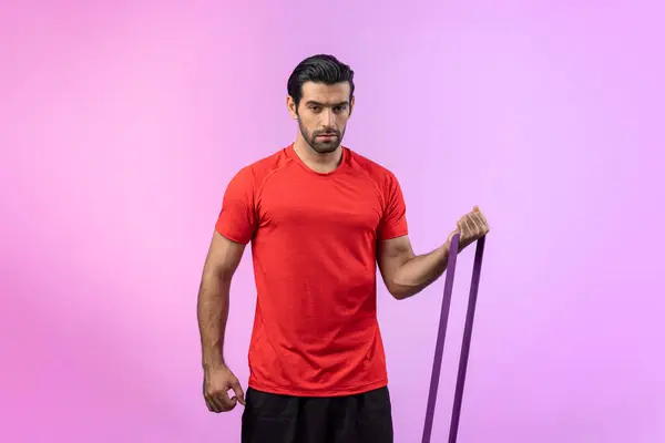 Full body length gaiety shot athletic and sporty young man with fitness elastic resistance band in standing posture on isolated background. Healthy active and body care lifestyle.