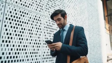 Akıllı iş adamı iş yatırımları hakkında konuşmak için telefonu kullanıyor. İş planı, pazarlama stratejisi ya da çalışma hakkında konuşmak için akıllı telefonla konuşurken sokakta yürüyen mutlu bir yönetici. Sevinçli..