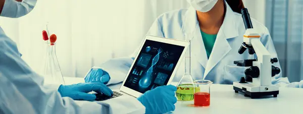 Laboratory research team advance healthcare with scientific expertise, laboratory equipment, and innovative medical biotechnology software, researching new medicines and developing cure.Panorama Rigid