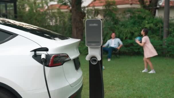 행복하고 장난스러운 가족의 배경에 충전소에서 자동차 미래를위한 가능한 에너지를 사용하는 — 비디오