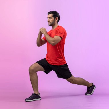 Vücut uzunluğunun tamamı atletik ve sportif genç bir adam tarafından izole edilmiş arka planda egzersiz pozisyonunda çekilmiştir. Sağlıklı aktif ve vücut bakımı yaşam tarzı.