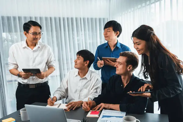 Group of diverse office worker employee working together on strategic business marketing planning in corporate office room. Positive teamwork in business workplace concept. Prudent