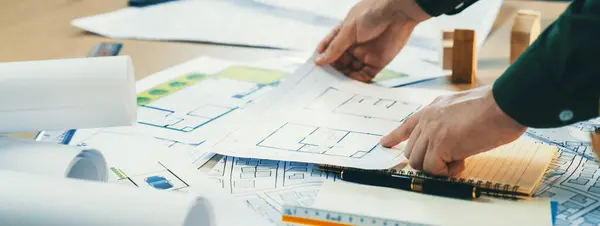 Portrait Experienced Male Architect Hand Chooses Blueprint Messy Table Architectural — Stock Photo, Image