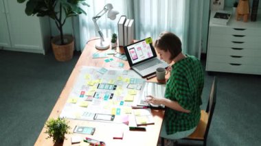 Yönetici tasarımı UX, UI sisteminin en üst görünümü masada otururken ve program sistem görüntüsü tabletine bakarken. Beyin fırtınası fikrine yapışkan not ve zihin haritası kullanarak lider yazma fikri..
