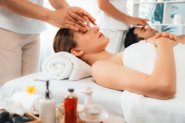 Kafkasyalı çift stres önleyici kafa masajının keyfini çıkarıyor ve lüks otellerde ya da otel spa salonlarında gündüz kaplıcalarında yüz güzelliği eğlencelerini şımartıyor. Sessiz.