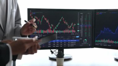 Hisse senedi borsası pazarlamasını analiz eden yavaş çekim şirketindeki yatırımcılar, kayıp için mum bar fiyatını analiz eden monitörlere bakıyor ve kazanç ve kâr elde ediyor. Filizlenen