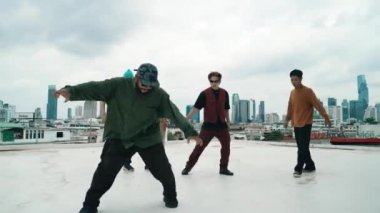 Çatıda çok kültürlü arkadaşlar varken profesyonel İspanyol break dansçısı B boy dansı. Genç modern dans grubu hip hop hareketi yapıyor. Tarz, moda, aksiyon. Açık hava sporu 2024 hiphop..