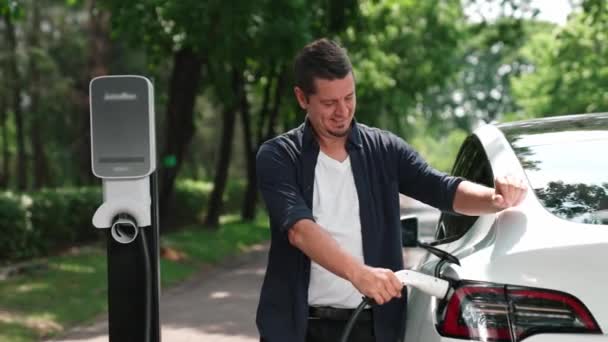 Man Recharging Battery Electric Car Road Trip Travel Car Natural — Stock Video