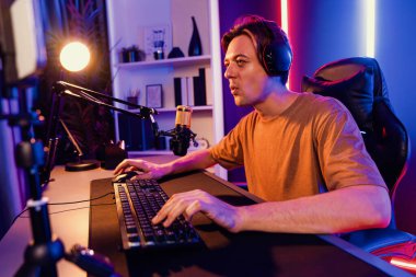 Kazanmak için çevrimiçi oyun oynayan akıllı flama makinesinin sunucu kanalı, neon ışıklı odada seçilen takım yarışması için izleyicilerle birlikte canlı yayında canlı yayında kulaklık takıyor. Bireysel.