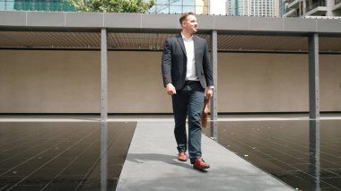 İş adamlarının bavullarını tuttukları ve şehir merkezindeki iş yerine yürüdükleri ön manzara. Profesyonel proje yöneticisi dışarıda resmi takım elbise giyerken toplantıya gidiyor. Urbane.