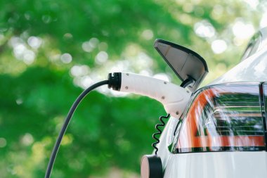 Green City Park 'taki otoparkta EV elektrikli araba şarj bataryası. Sürdürülebilir ve çevre dostu şehir yolculuğu için yenilenebilir otomobil için alternatif temiz enerji teknolojisi. Yararlı